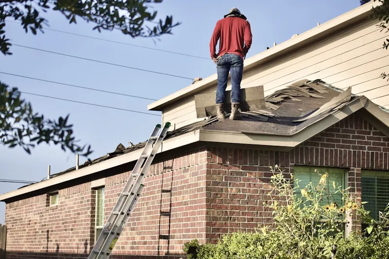 Professional roofer working on a residential roof in North Haven